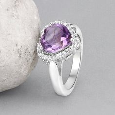 "Amethyst Ring, Halo Amethyst Heart Silver Ring, Natural Amethyst Ring for Women, February Birthstone Ring Flaunt yourself with this amethyst & white topaz halo ring. The natural gemstones have a combined weight of 3.53 carats and are set in .925 sterling silver with rhodium plating. The purple hue of this ring adds a pop of color to any look! The understated design and vibrant stones make this ring perfect for every occasion. amethyst halo silver ring, amethyst ring, amethyst silver ring, n Heart Cut Amethyst Ring With Accent Stones, Heart Cut Amethyst Jewelry With Center Stone, Fine Jewelry Amethyst Ring Heart Cut, Fine Jewelry Heart Cut Amethyst Ring, Purple Amethyst Heart Ring With Gemstone, Purple Amethyst Diamond Ring, Heart-shaped Amethyst Ring With Accent Stones, Purple Gemstone Heart Ring For Promise, Purple Gemstone Heart Ring Fine Jewelry