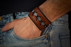 Creation of this unique leather bracelet is influenced by steampunk and gothic style and culture.  It is made from two layers of leather, that been decorated with black leather string and piece of blue jeans. Closure is provided by two brass snap buttons. This bracelet comes in special box that could be laser engraved with your gratulation to someone. For example; Happy birthday John Contact me and tell about your gift message. Purchase contains bracelet and paper gift box. Billiard balls are not included. Steampunk Leather Bracelet As A Gift, Punk Leather Cuff Bracelet As Gift, Hand-tooled Leather Cuff Bracelet, Adjustable Leather Punk Cuff Bracelet, Happy Birthday John, Handmade Punk Leather Bracelet, Adjustable, Leather Wrist Cuff, Steampunk Bracelet, Gothic Bracelet