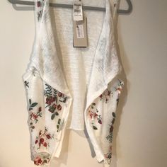 Embroidered White Vest, Draped Open Front, Sleeveless, Draped Over Lay With Floral Embroidery. Made In Italy. Sold Out At Nordstrom’s. Nwt With Small Stain Than Will Wash Out - See Photo. Pit To Pit: 24” Length: 27” Condition: Excellent Sleeveless Embroidered Spring Vest, Spring Embroidered Sleeveless Vest, Embroidered Sleeveless Vest For Spring, Spring Sleeveless Embroidered Vest, Sleeveless Embroidered Vest For Spring, White Embroidered Summer Vest, Sleeveless Spring Embroidered Top With Floral Embroidery, Sleeveless Embroidered Floral Top For Spring, Sleeveless Floral Embroidered Top For Summer