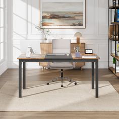 a desk with a laptop on it in front of a bookcase and bookshelf