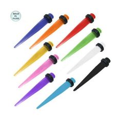 six different colored plastic darts with black tips