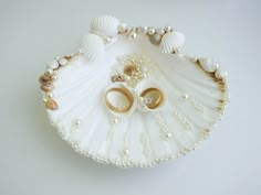 "This romantic Sea Shell Ring Holder is decorated with pearl beads and natural seashells. This ring holder is  4,6\" (11.5 сm.) and is perfect for your beach wedding.  Rings are not included.  Here you can see our offer for sea bridal belt: https://www.etsy.com/listing/570543589/beach-wedding-sash-shell-bridal-sash?ref=shop_home_active_9&frs=1 https://www.etsy.com/listing/627502050/beach-wedding-sash-shell-bridal-sash?ref=unav_listing-same-5&cns=1 Customization is available: - Request personaliz Ring Bearer Beach Wedding, Shell Ring Bearer, Shell Ring Holder, Engagement Ring Platter, خواتم خطوبة, Seashell Ring, Wedding Ring Holder, Wedding Ring Shapes, Wedding Gift Pack