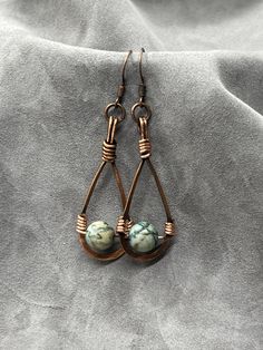 Handmade and wire wrapped in antique copper earrings with jasper accent bead Hand Wrapped Copper Dangle Earrings, Rustic Wire Wrapped Copper Jewelry, Wire Wrapped Teardrop Copper Jewelry, Artisan Hand Wrapped Copper Earrings, Copper Teardrop Wire Wrapped Jewelry, Hand Wrapped Copper Teardrop Jewelry, Copper Wire Wrapped Teardrop Earrings As Gift, Wire Wrapped Copper Drop Earrings, Artisan Wire Wrapped Copper Earrings