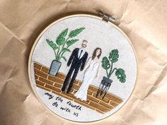 a couple is standing in front of a potted plant with the words my husband and wife on it