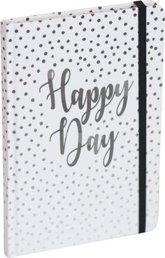 a white dotted notebook with the words happy day written in black ink on it's cover