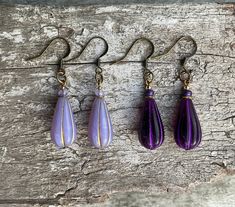 ✦Long deep deep purple or lavender purple/Bronze drop bohemian Czech glass with gold spacer, purple rondelle bead, topped with gold bead on earrings. ✦These boho beauties dangle 51mm from the top of nickel free brass ear wires. Width 10mm. ✦Option of deep purple or Lavender purple earrings. For all free spirited women who want to enjoy their unique style! 100% artisan made. Purple Teardrop Bohemian Earrings, Purple Czech Glass Earrings For Gift, Purple Long Drop Earrings With Ear Wire, Purple Teardrop Wire-wrapped Earrings, Purple Teardrop Wire Wrapped Earrings, Bohemian Lavender Drop Earrings, Purple Dangle Teardrop Earrings With Ear Wire, Purple Nickel-free Teardrop Dangle Earrings, Hypoallergenic Purple Bohemian Earrings