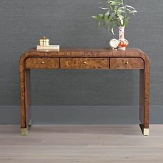 a wooden table with two drawers and a plant on top