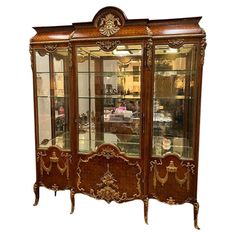 an antique display cabinet with glass doors