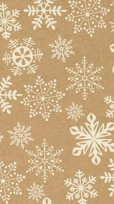 snowflakes on brown paper with white outlines in the shape of numbers and symbols