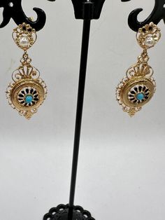 A unique opportunity for a wonderful pair of vintage 14K yellow gold dangle earrings. These unique earrings are hallmarked 14K on the bottom dangle and are guaranteed to be such. These gorgeous earrings have 2 dangles. The top dangle looks like a circle, which houses a 3.3mm pearl and what looks to be a crown. The bottom dangle features an elaborate design with a center blue stone, perhaps a tourquoise? The intricacy of the design is impressive. These are post earrings with butterfly closures. These beauties are 2 3/4" long and just under 3/4" at their widest. They are an impressive 6.31 grams. These are fabulous pair of earrings and perfect for a special occasion or for that person who just wants some thing very different! Gold Dangle Earrings, Earrings Unique, A Circle, Gold Earrings Dangle, Gorgeous Earrings, Unique Earrings, Fort Worth, Blue Stone, Post Earrings