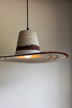 a hat hanging from a light fixture in a room