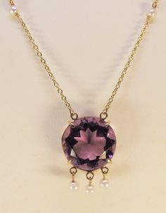 "A beautiful 17mm faceted amethyst forms the focal point of this impressive pendant. Three 4mm pearls dangle delicately from beneath the stone, and four more 3mm pearls accent the 14 karat yellow gold chain. The necklace measures 17.5\" in total length." Elegant Faceted Drop Necklaces, Elegant Amethyst Jewelry With Pearl Pendant, Classic Faceted Pendant Necklace, Classic Amethyst Necklaces For Wedding, Formal Drop Amethyst Necklaces, Formal Amethyst Drop Necklace, Formal Drop Amethyst Necklace, Elegant Purple Pearl Necklace For Formal Occasions, Elegant Purple Pearl Necklace For Wedding