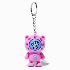 a pink bear keychain with a heart on it's chest and a peace sign in the middle