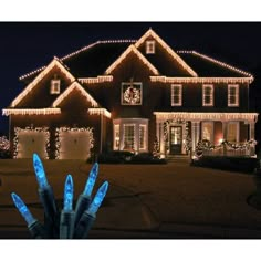 a large house covered in christmas lights at night