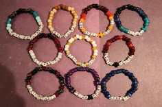 six bracelets with words on them sitting next to each other, all in different colors