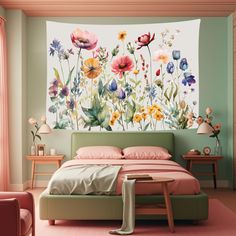 a bed room with a neatly made bed and flowers on the wall