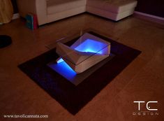 an illuminated box sitting on top of a rug in the middle of a living room