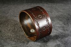 a wooden ring with an intricate design on it