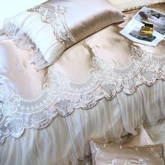 a bed with two pillows and some pictures on the pillowcase, along with other decorative items