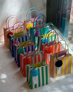 many colorful bags are lined up on the ground