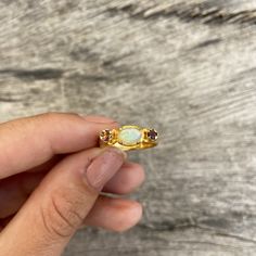 Choose between these gorgeous polished Ethiopian opal rings with amazing sparkles set in sterling silver and then gold plated. The ring has a little different faceted tourmaline on each side of the main stone. Choose between: Blue and yellow- N 1/2 (UK/AU size ring) 6 3/4 (US size) Green and brown- L 1/2 (UK/AU size ring) 5 7/8 (US size) Blue and pink- N 1/2 (UK/AU size ring) 6 3/4 (US size) Pink and brown- M 1/2 (UK/AU size ring) 6 1/4 (US size) This ring would make the most perfect bridesmaid' Gold Opal Multi-stone Ring, Gold Ethiopian Opal Ring Hallmarked, Gold Opal Ring With Birthstone, Gold Opal Birthstone Ring, Gold Ethiopian Opal Ring For Anniversary, Yellow Gold Ring With Ethiopian Opal And Birthstone, Yellow Gold Ethiopian Opal Ring With Birthstone, Dainty Gold Opal Ring For Anniversary, Yellow Gold Ethiopian Opal Birthstone Ring