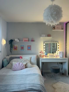 a bedroom with a bed, desk and vanity in the corner next to a window