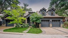 a large house with two garages and landscaping