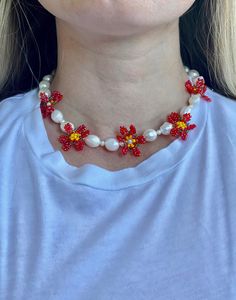 "Large and small freshwater pearls are alternately strung along gold plated jewelry wire and paired with hand beaded seed bead flowers. This necklace is ready to become the focal point of any outfit and can be worn casually or dressed up! Finished with a gold plated adjustable clasp this necklace can be work from 15.5\" to 17.25\". Remove before bathing, showering, and working out." Beaded Flower Pearl Necklace, Flower Shaped Beaded Pearl Necklace, Flower-shaped Beaded Pearl Necklace, Beaded Flower-shaped Pearl Necklace, Pearl Beaded Necklace With Flower Shape, Flower Shaped Beaded Pearl Necklace Gift, Flower-shaped Beaded Pearl Necklace For Gifts, Pearl Flower Beaded Necklace, Pearl Round Beads Jewelry For Spring