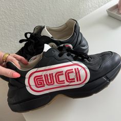 Men's Gucci Rhyton Sega Black And Red Sneakers. Used But Good Condition. Size 10.5. Gucci Rhyton Sneakers Black, Designer Logo Print Sneakers With Round Toe, Gucci High-top Logo Sneakers, Gucci High-top Sneakers With Logo, Gucci Sneakers With Logo And Round Toe, Gucci Sneakers With Logo, Gucci Leather Sneakers With Logo, Designer Custom Lace-up Sneakers With Logo Print, Designer Custom Logo Print Lace-up Sneakers