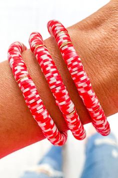 Candy Cane Heishi Bracelet | Bella Lucca Boutique Flexible Beaded Bracelets As A Gift, Red Heishi Beads Bracelet For Gift, Red Heishi Beads Friendship Bracelets As Gift, Red Heishi Beads Jewelry For The Beach, Adjustable Red Stackable Bracelets, Red Adjustable Stackable Bracelets, Red Heishi Beads Jewelry, Red Beaded Bangle Bracelets For Beach, Red Stackable Bracelets With Round Beads