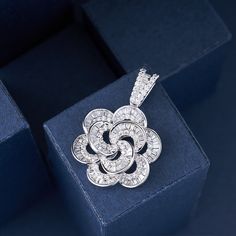 Introducing our Designer Luxury Crystal Camellia Flower Pendant, an elegant and timeless jewelry piece made with high-quality 925 silver. This exquisite pendant features a beautifully crafted camellia flower design, adorned with sparkling crystals that catch the light for a truly captivating effect.Inspired by the delicate beauty of camellia flowers, this pendant offers a sophisticated and refined touch to any outfit. The combination of luxurious crystals and premium 925 silver ensures a durable Camellia Flowers, Camellia Flower, Delicate Beauty, Timeless Jewelry, Elegant Accessories, Sparkling Crystal, Flower Pendant, Flower Design, Flower Designs