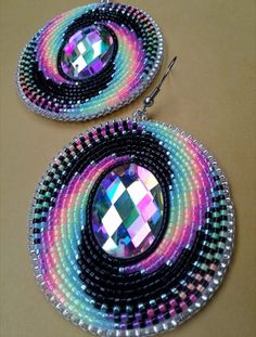 pair of earrings with multicolored design on them