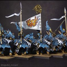 the warhammers are painted in blue and gold with white flags on their heads