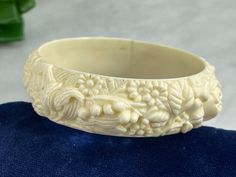 "A lovely flower bangle bracelet, in a cream color plastic. The flowers include roses, mums, and lily of the valley. No marks. Measures about .84\" wide, and about 8\" around on the inside. Some marks/wear to the finish. Actual packaging will vary depending on item/s purchased and tape pattern available. Props shown in photos is for display purposes only, not included in this listing. As always, satisfaction is guaranteed. Thanks for shopping Vintage In Bloom More bracelets: http://www.etsy.com/shop/VintageInBloom?section_id=5488599 Back to my shop: http://www.etsy.com/shop/vintageinbloom BRC05" Vintage White Bangle For Wedding, Vintage White Wedding Bangle, Vintage White Flower Bracelets, Plastic Bracelets, Tape Pattern, Bridal Jewellery Design, Glass Butterfly, Stick Pins, Modest Fashion Outfits