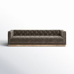 a brown couch sitting on top of a white floor