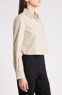 A cropped silhouette balanced by a slightly boxy fit enhances the breezy look of this button-up shirt cut from smooth poplin. Hidden-button placket Point collar Long sleeves with button cuffs Chest patch pocket 53% cotton, 47% polyester Dry clean Imported Classic Cropped Button-up Shirt With Button Cuffs, Chic Button-up Cropped Workwear Shirt, Chic Button-up Cropped Shirt For Work, Chic Collared Cropped Shirt For Work, Chic Collared Poplin Top, Chic Cropped Shirt With Collar For Work, Chic Collared Cropped Shirt For Office, Classic Cropped Shirt With Button Closure, Classic Spring Cropped Shirt With Button Cuffs