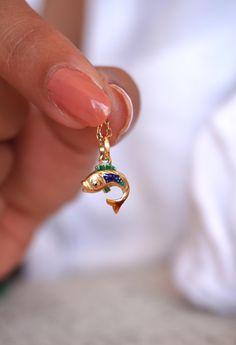 Elevate your jewelry collection with my exquisite Handmade 14k Gold Enamel Koi Charm, a perfect blend of artistry and luxury. Meticulously crafted by me, this charm features a vibrant koi fish, symbolizing perseverance, strength, and good fortune. The 14k gold setting provides a rich, timeless foundation, while the hand-painted enamel detailing brings the koi to life with its vivid colors and intricate design. This charm is more than just a piece of jewelry--it's a meaningful talisman that carries the deep symbolism of the koi fish, making it an ideal gift for someone who embodies resilience or is embarking on a new journey. Whether added to a bracelet or worn as a pendant, this charm will infuse any outfit with elegance and a touch of cultural significance. **EACH CHARM IS UNIQUELY CRAFTE Enamel Fish-shaped Jewelry For Gifts, Enamel Fish-shaped Jewelry As Gift, Fish-shaped Enamel Jewelry As A Gift, Fish-shaped Enamel Jewelry For Gifts, Fish-shaped Enamel Jewelry Gift, Handmade Fish-shaped Jewelry Gift, Gold Color Ring, Fish Jewelry, Enamel Necklaces