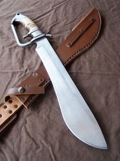 a knife is laying on top of a leather sheath