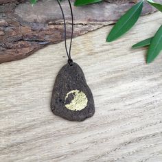 a rock with a gold leaf on it