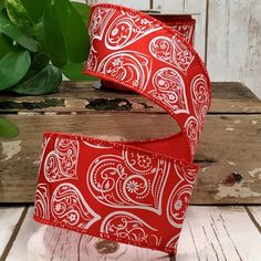 two red and white patterned ribbon on wooden surface