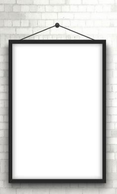 a white brick wall with a black frame hanging on it's side, and an empty