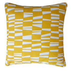 a yellow and white pillow with squares on it