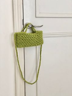 a crocheted purse hanging on a door handle