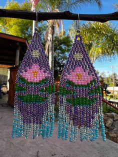 Very pretty beaded earrings with a beautiful pink lotus flower and water scenery within the design. The colors are vibrant and soothing to see! These are light weight and simple exquisite.  You can choose different colors for the lotus flower :) Lotus Beaded Earrings, Handmade Purple Beaded Earrings For Beach, Bohemian Turquoise Beaded Flower Earrings, Bohemian Purple Beaded Earrings For Beach, Bohemian Flower Earrings With Dangling Beads, Bohemian Dangle Flower Earrings For Beach, Handmade Purple Bohemian Tassel Earrings, Purple Bohemian Handmade Tassel Earrings, Handmade Bohemian Purple Tassel Earrings