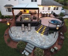 an aerial view of a house with a patio and fire pit in the middle of it