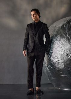 Editor's Note Featuring tone on tone embroidered dire black tux with kat dana details. Paired with a black pintuck shirt and black tapered trousers. Fabric: Linen silk Color: Black Components: Tuxedo, shirt and trousers Occasion: Evening wear Fit: Regular Note: Product colour may slightly vary due to photographic lighting sources Care: Dry clean only About the Designer After establishing himself as the leading couturier in the industry of menswear, Jatin Malik went on to explore luxury footwear. Designer Black Blazer With Pressed Crease, Fitted Party Wear Sets For Evening, Luxury Tailored Sets For Evening, Luxury Tailored Evening Sets, Black Fitted Bandhgala For Semi-formal Occasions, Black Tuxedo With Pressed Crease For Evening, Black Silk Tuxedo For Party, Black Evening Tuxedo With Pressed Crease, Festive Tuxedo Sets For Party