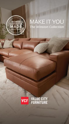 a large brown leather couch sitting on top of a white rug in front of a window