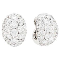 Graff Pair of White Gold and Diamond Dome Ear-clips This pair of earrings are oval domes of 48 round diamonds approx. 16.20 carats., edged by 64 small round diamonds approx. 1.75 carats all set in 18k white gold and clip-backs with collapsible posts, Signed Graff. With signed pouch. Measurements: ⅞ x 5/8 inch. Luxury White Clip-on Diamond Earrings, White Diamond Clip-on Earrings, Luxury Oval Diamond White Diamond Earrings, White Round Clip-on Diamond Earrings, Luxury Oval Diamond Earrings With Pave Setting, Luxury Oval Clip-on Earrings For Anniversary, Classic Diamond Clip-on Earrings With Brilliant Cut, Diamond Clip-on Earrings Fine Jewelry, Classic Clip-on Diamond Earrings