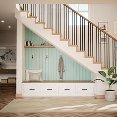 there is a coat rack under the stairs in this room with white cabinets and drawers