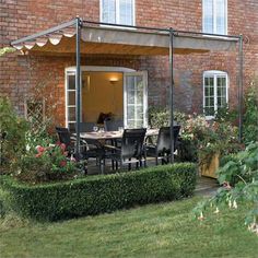 an outdoor dining area in front of a brick building